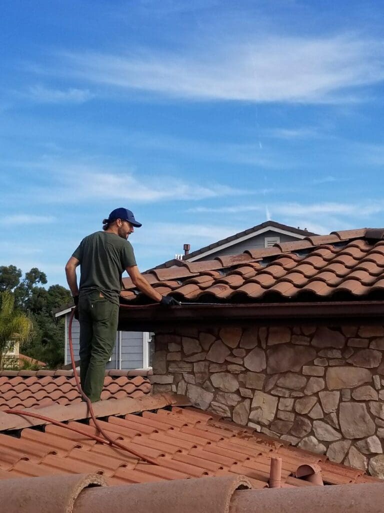 A man standing on top of a roof looking at the sky.