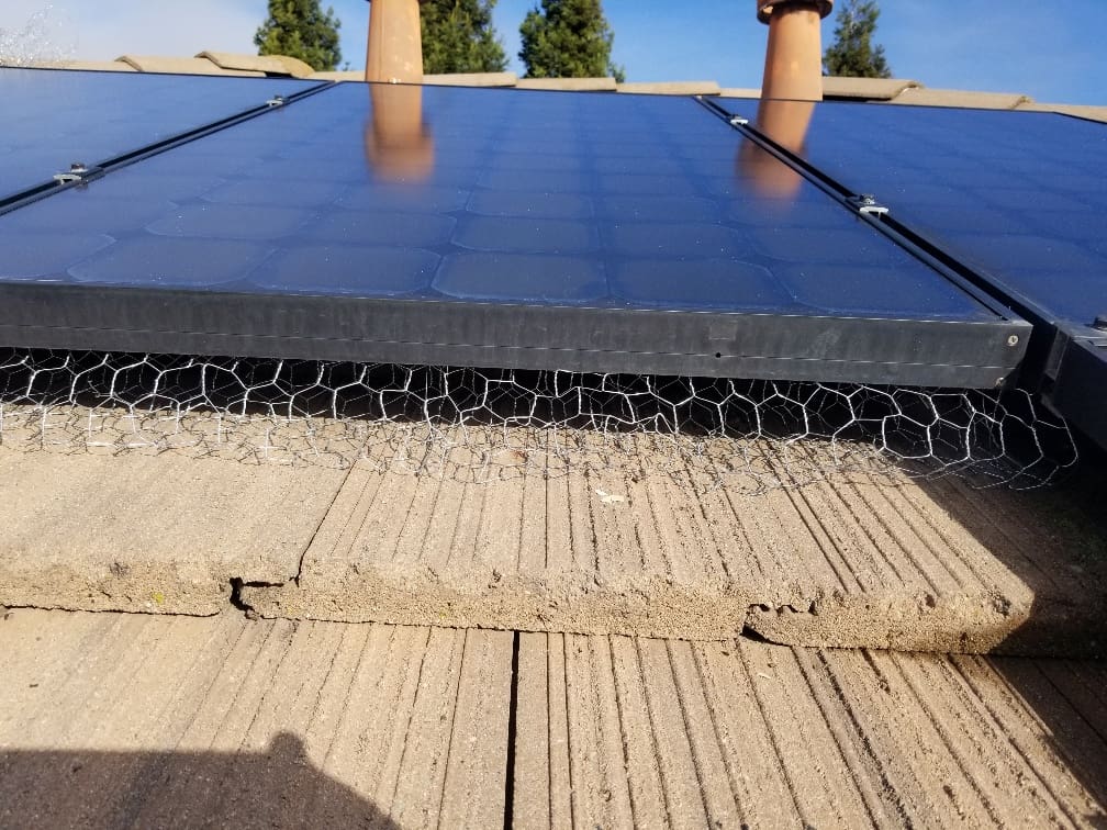 A solar panel sitting on top of a roof.