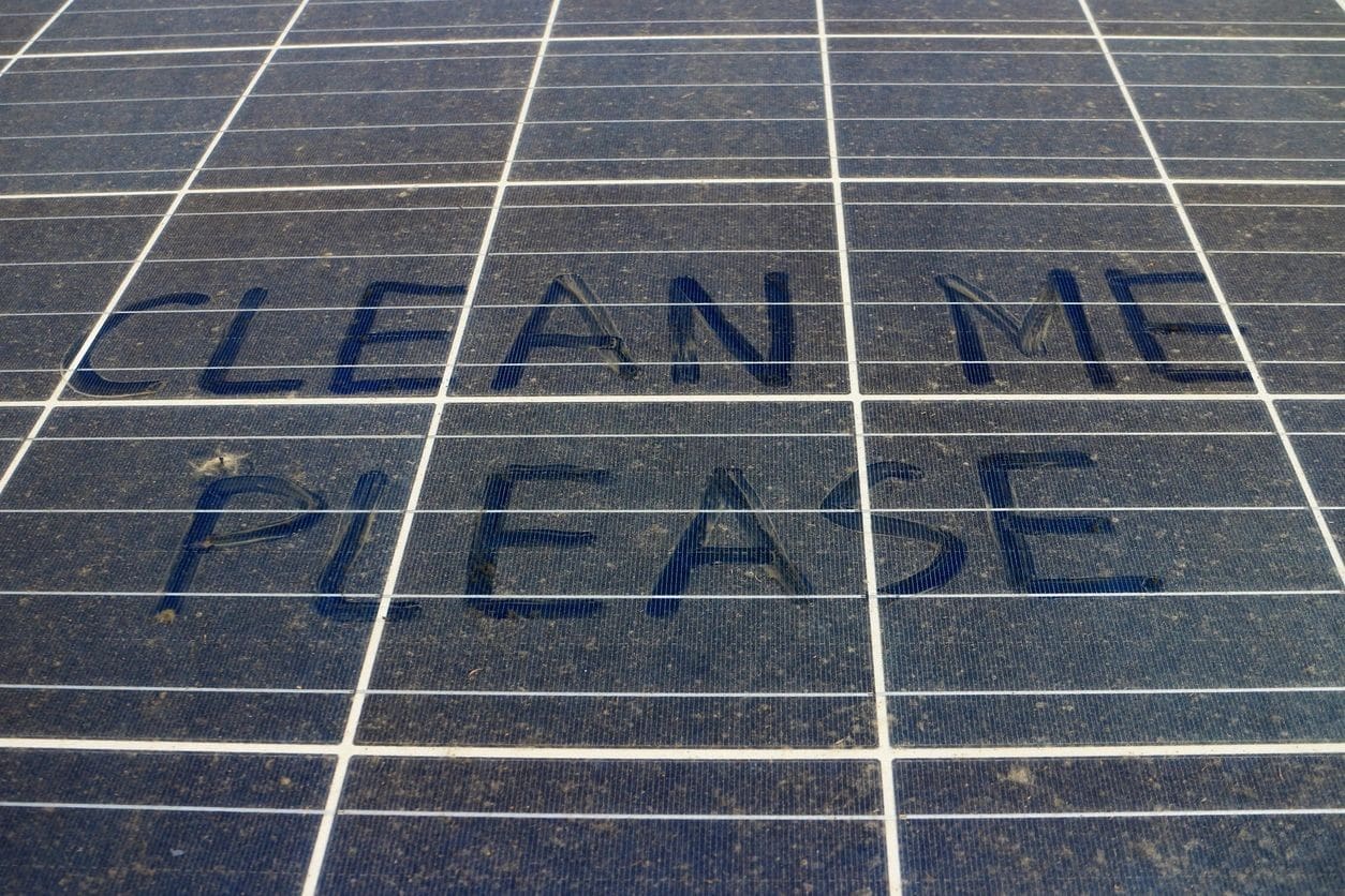A close up of the words clean me please written on a tile floor