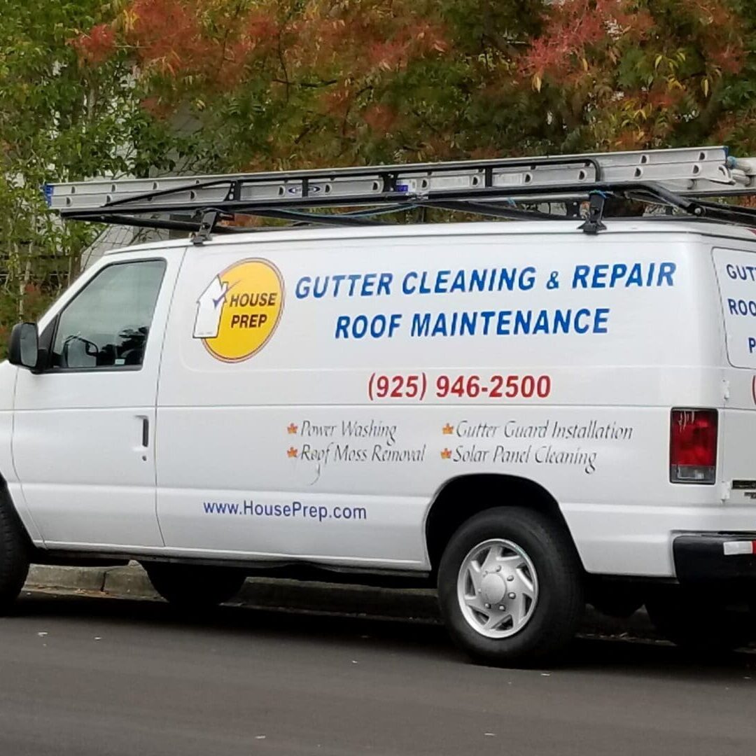 A professional technician providing gutter cleaning to a client.