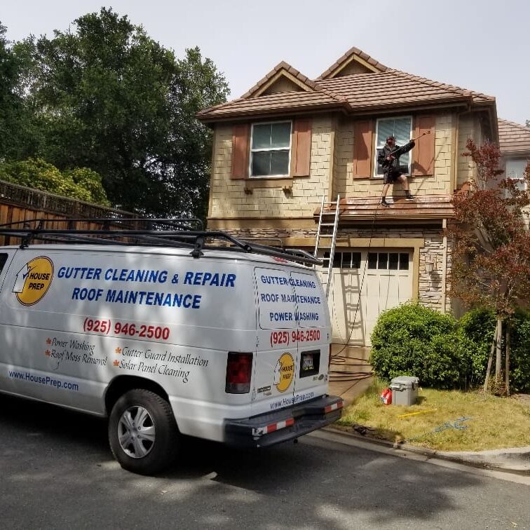 A white van parked in front of a house.