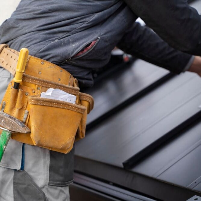 Gutter repair expert working in a property in Oakland, CA.