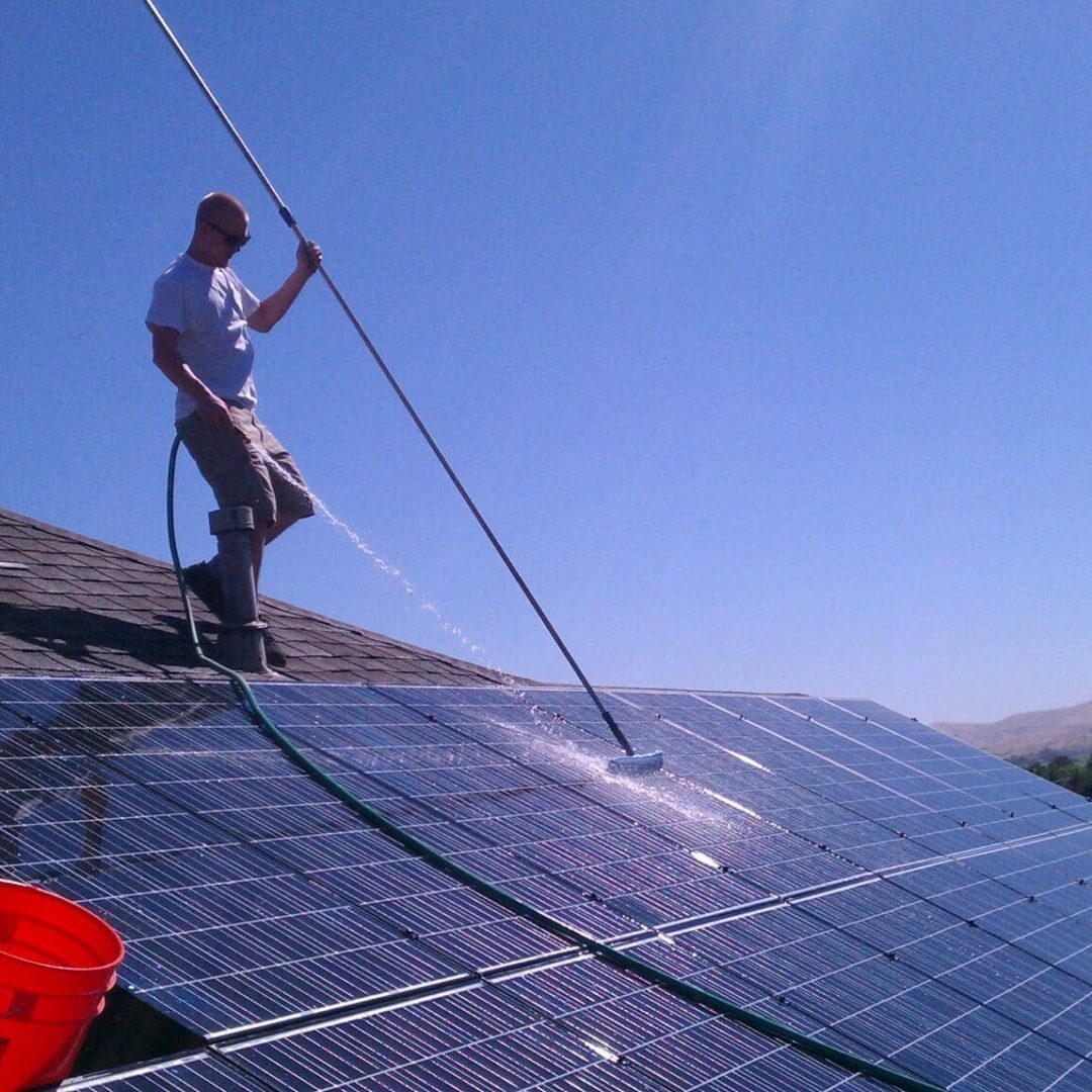 A professional advising a client about gutter cleaning.