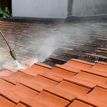 A House Prep technician cleans a roof using soft washing.